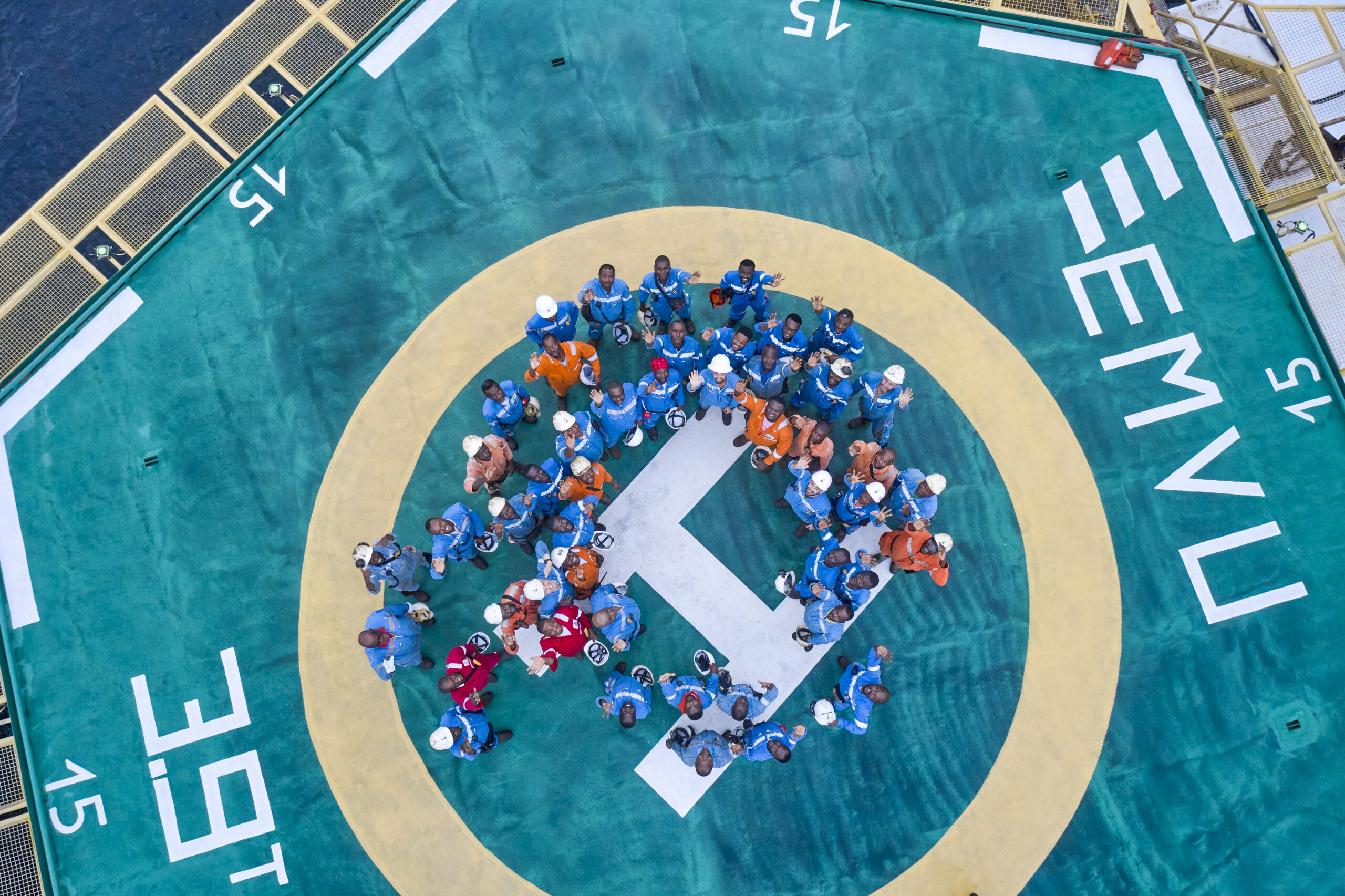 Bunch of working men looking up with hands in the air in Congo 