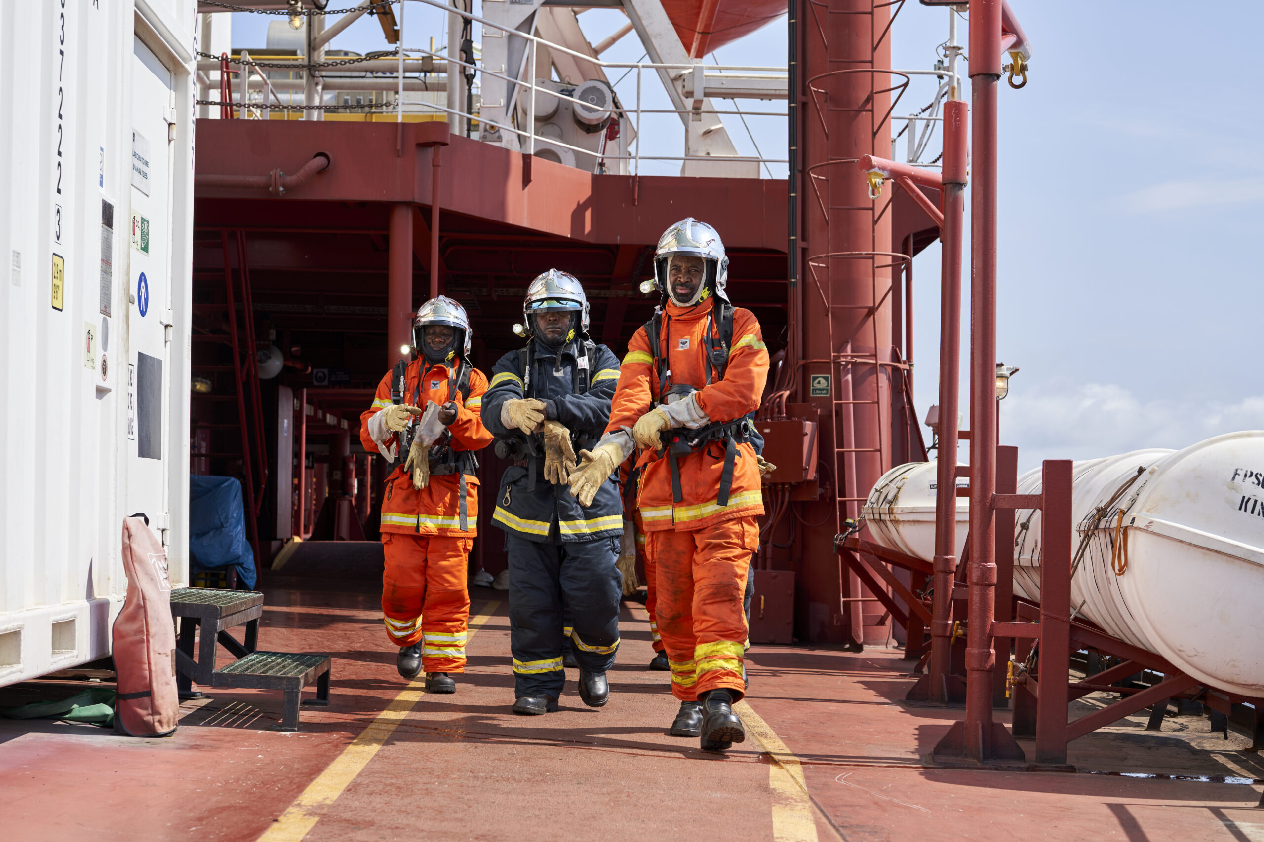Three working men walking on the boat in Congo 