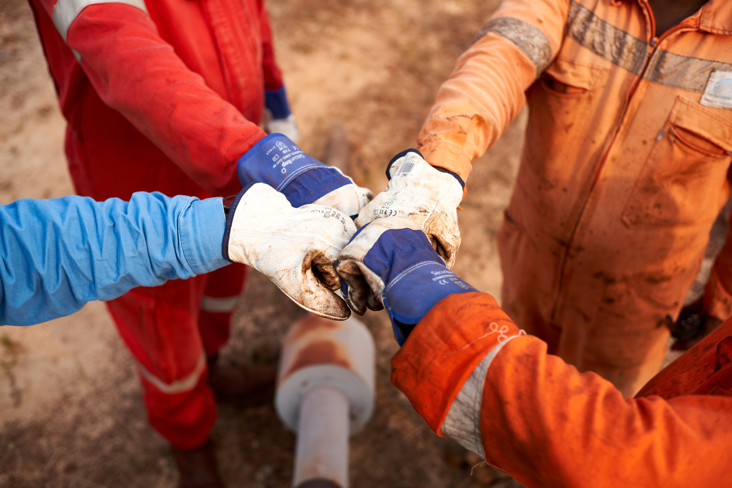 Workers making unit with hands in Gabon
