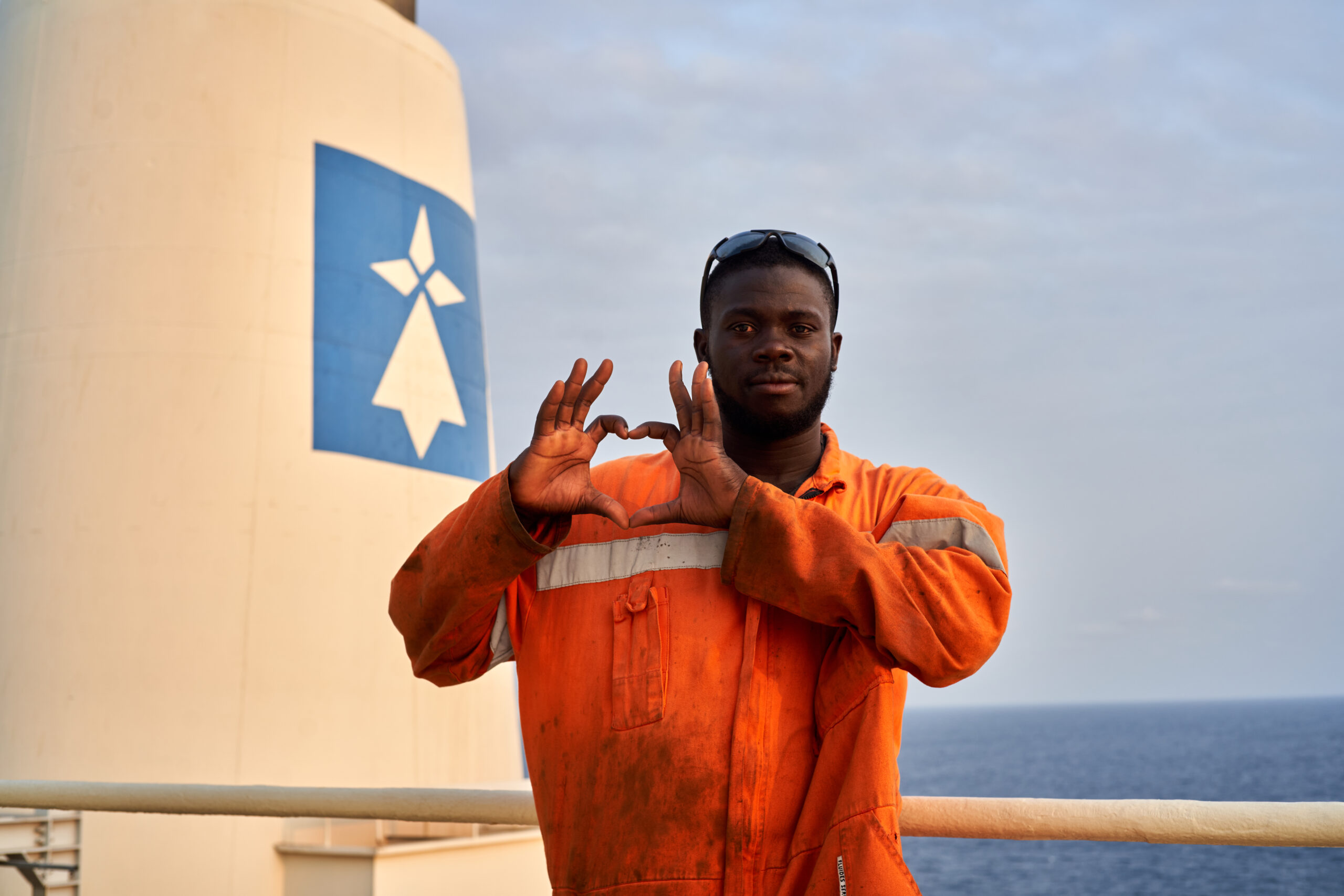 Man forming a heart with his hands in Gabon