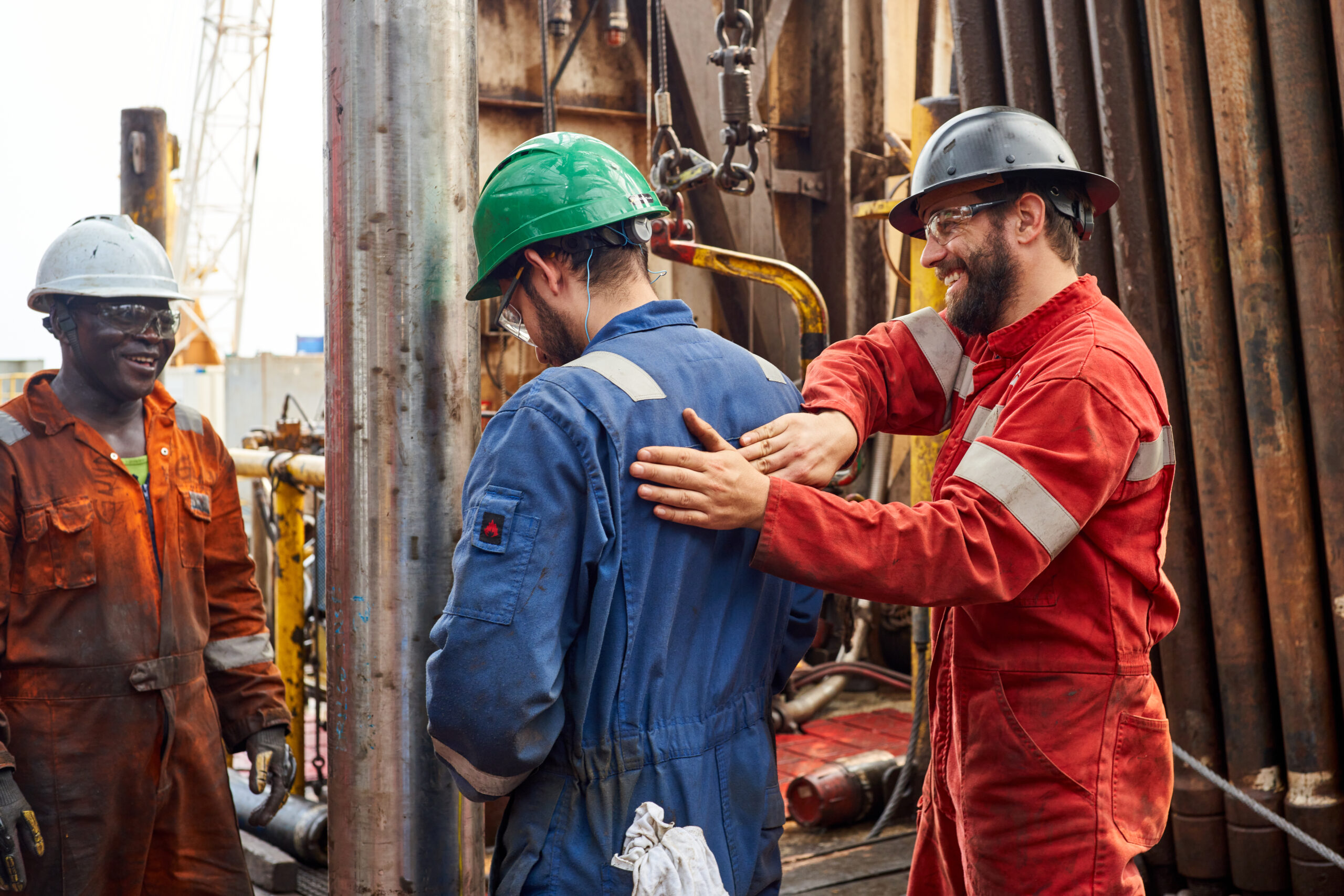 Three workers smiling onboard in Gabon