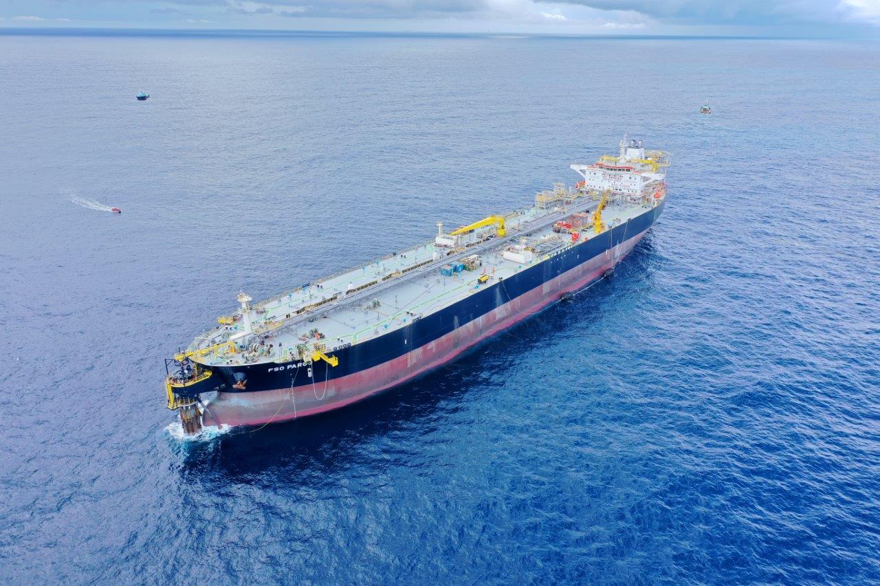 Floating long cargo boat seen from above 