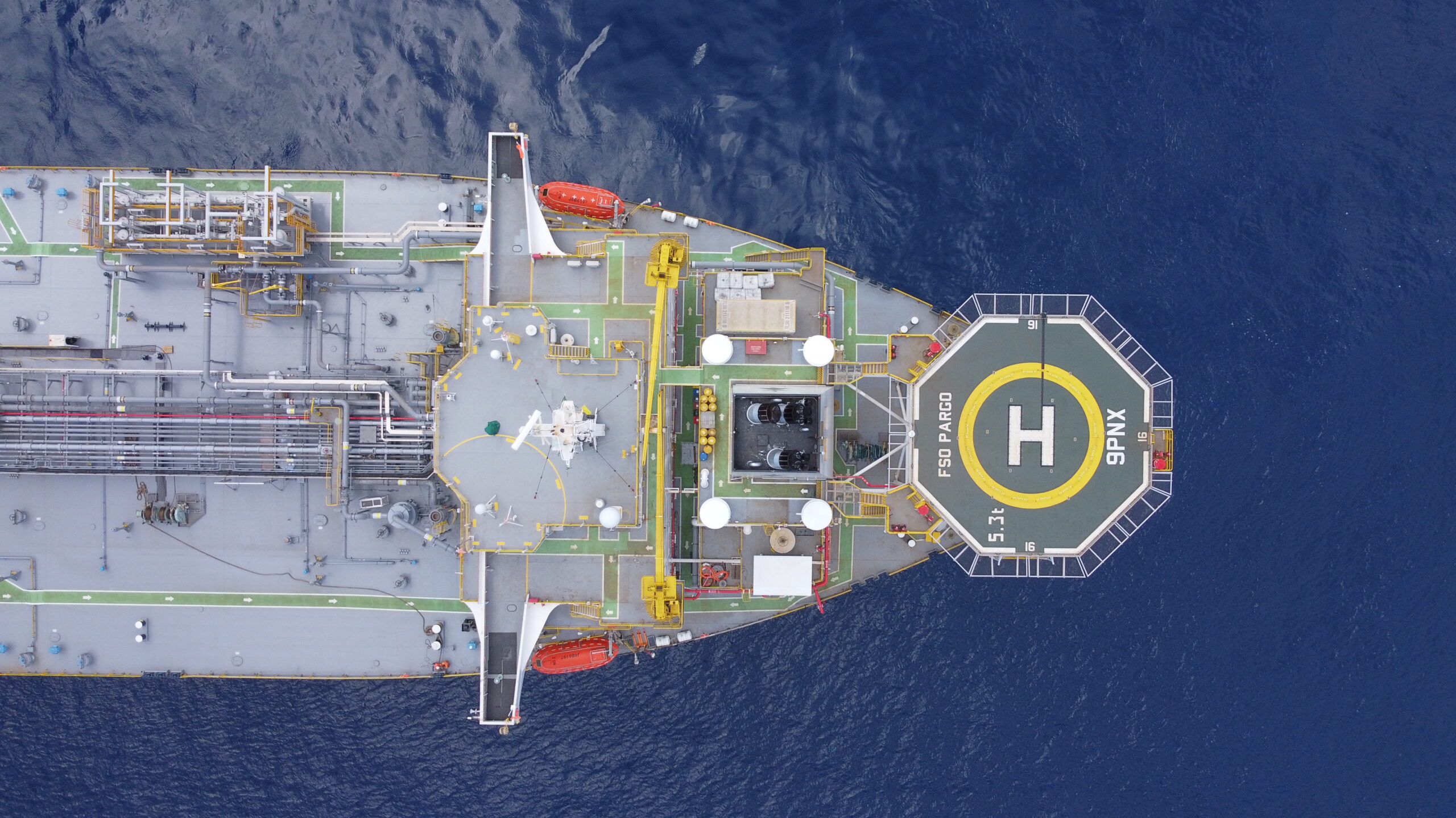 Close up on front long cargo boat seen from above